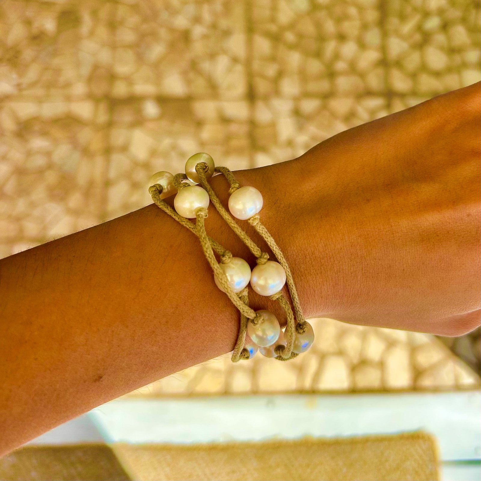 Adjustable freshwater pearl bracelet worn on wrist – beachy boho style
